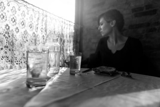 black-white-woman-along-at-table-drinking-gratisograph-ryan-mcguire